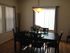 A dimly lit dining room with dark furniture. | Peterson AFB Housing, Colorado Springs, CO