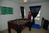 A foosball table and punching bag in dimly lit room. | Military-Friendly Houses for Rent Colorado Springs, CO