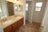A brightly lit bathroom with two sinks and light cabinets. | Peterson AFB Housing, Colorado Springs, CO