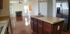 A kitchen and living room area with dark flooring and cabinets. | Military-Friendly Houses for rent Colorado Springs, CO