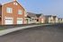 Several homes and garages on a empty street. | North Haven Communities at Fort Wainwright