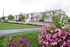Beautifully Landscaped Grounds outside of several white and red, two-story homes. | Housing Fort Wainwright | North Haven Communities at Fort Wainwright