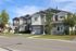 Several gray homes with American flags hanging out front. | North Haven Communities at Fort Wainwright