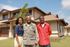 Airman with woman and teenager in front of home | Hickam Communities | Hickam Communities