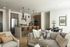 Elegant open-concept living space with modern kitchen, dining area, and stylish seating.
