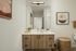 Contemporary bathroom with sleek vanity, large mirror, and stylish decor.