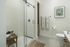 Contemporary bathroom with glass shower, stylish decor, and modern amenities.