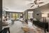Inviting living room with modern decor and cozy ambiance, featuring plush seating, elegant lighting, and a scenic window view.