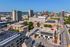 Vibrant cityscape showcasing modern apartments amidst downtown skyline, highlighting urban convenience and lively atmosphere.