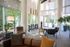 Bright and inviting lounge area with modern seating, large windows, and lush greenery, offering a serene atmosphere.