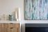 Elegant modern interior featuring an abstract painting, stylish geometric decor, and sleek furniture for a sophisticated aesthetic.