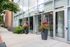 Modern glass entrance to Park Lafayette Towers with beautiful flower arrangements and upscale design.