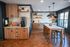 Beautiful modern kitchen with sleek wooden cabinets, elegant pendant lighting, and a spacious island with seating.