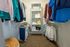 Spacious and organized walk-in closet featuring neatly arranged clothing and shelving for stylish storage solutions.
