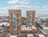 Stunning twin high-rise apartments overlooking a wintery cityscape with lake views, offering modern living in an urban setting.