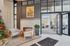 Elegant lobby with cozy seating by a modern fireplace, a festive Christmas tree, and expansive windows flooding the space with natural light.