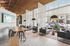 Chic and modern lounge area with stylish gray sofas, natural wood accents, and large windows allowing abundant natural light.