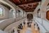Stunning loft apartment with elegant arches, intricate columns, and vibrant stained glass windows, featuring a spacious open-concept living area and dining space.