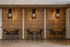 Chic dining area with modern pendant lights, sleek black chairs, and warm wooden accents, perfect for a contemporary apartment setting.