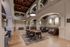Elegant communal space with high ceilings, arched architecture, and cozy seating areas under beautiful stained-glass windows.