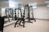 Sleek and modern apartment gym featuring high-quality exercise equipment and mirrored walls for an enhanced workout experience.