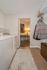 Chic laundry room featuring a modern washer and dryer, elegant decor, and ample shelving in a cozy apartment setting.