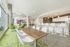 Modern open-concept lounge with elegant seating, stylish bar stools, and ambient lighting perfect for relaxation and entertainment.