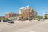 Vibrant urban scene showcasing a modern apartment complex with balconies, lively street, and iconic water tower landmark.