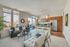 Bright and modern apartment living area featuring a sleek open-concept kitchen with stainless steel appliances and contemporary decor accents.