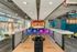 Chic recreational area showcasing a modern bowling alley with vibrant neon lights and stylish seating.