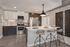 Modern kitchen with sleek stainless steel appliances, elegant island seating, and stylish cabinetry, perfect for entertaining.