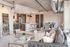 Contemporary open-concept living and dining area with stylish decor, featuring a modern kitchen and elegant furnishings.