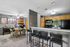 Inviting open-concept dining and kitchen area with modern appliances, cozy seating, and stylish decor.