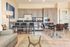 Modern apartment interior with an elegant open kitchen, sleek cabinetry, cozy dining area, and stylish living room.