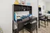 Contemporary workspace featuring a sleek black desk with ample shelving, ideal for productivity and style.