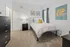 Bright and cozy bedroom with elegant decor, featuring a comfortable bed, modern furniture, and vibrant wall art.