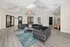 Elegant lounge area with modern black sofas and glass coffee table surrounded by a serene atmosphere and stylish decor.