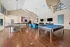 Inviting recreational room with sleek ping pong and pool tables, comfortable seating, and modern decor enhancing entertainment ambiance.