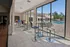 Modern community space with stylish bar seating and floor-to-ceiling windows offering a scenic pool view.