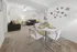 Inviting living space with modern decor, featuring two sleek sofas, a contemporary dining area, and chic geometric wall art.