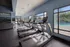 Modern fitness center with state-of-the-art treadmills overlooking a bright outdoor pool area, showcasing a healthy lifestyle within luxurious facilities.