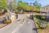 Inviting entrance to a vibrant community with lush greenery and secure gated access.