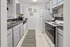Chic galley kitchen featuring modern appliances, sleek countertops, and stylish cabinetry, perfect for culinary creations.
