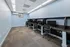 Chic and modern workspace with sleek black desks, ergonomic chairs, and soft blue walls creating an inviting atmosphere.