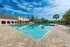 Luxurious outdoor pool area with pristine waters, surrounded by palm trees and modern amenities, perfect for relaxation and leisure.