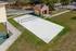 Inviting sand volleyball court set beside a charming brick building, perfect for outdoor recreation and relaxation.