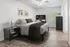 Elegant bedroom with modern decor, featuring a cozy bed, stylish artwork, and a work desk, illuminated by natural light from a large window.