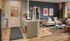 Modern kitchen and living room with stylish interior design, featuring a sleek countertop, vibrant wall art, cozy seating area, and abundant natural light.