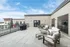 Expansive rooftop terrace featuring comfortable seating, a barbecue grill, and scenic views.