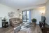 Stylish apartment living room with modern decor, large window, and chic furnishings.